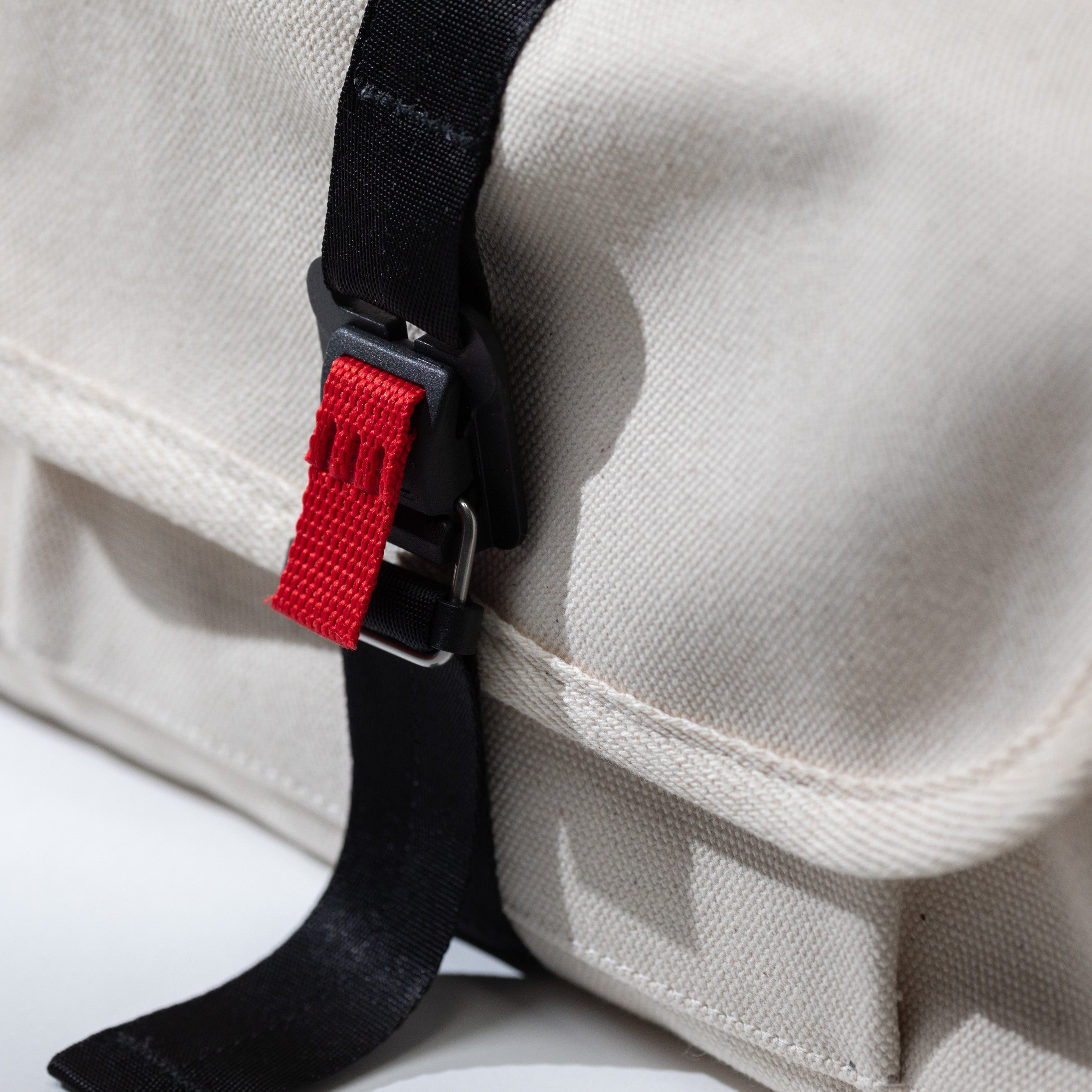 Close-up of the tech pouch's recycled canvas exterior buckle — durable everyday carry