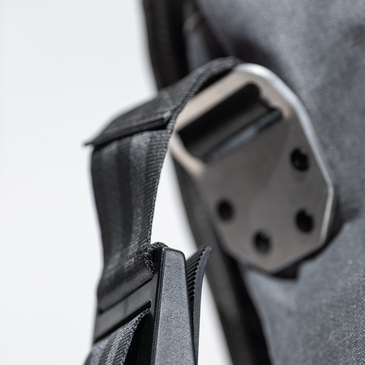 Close-up of the messenger bag's buckle and leather strap