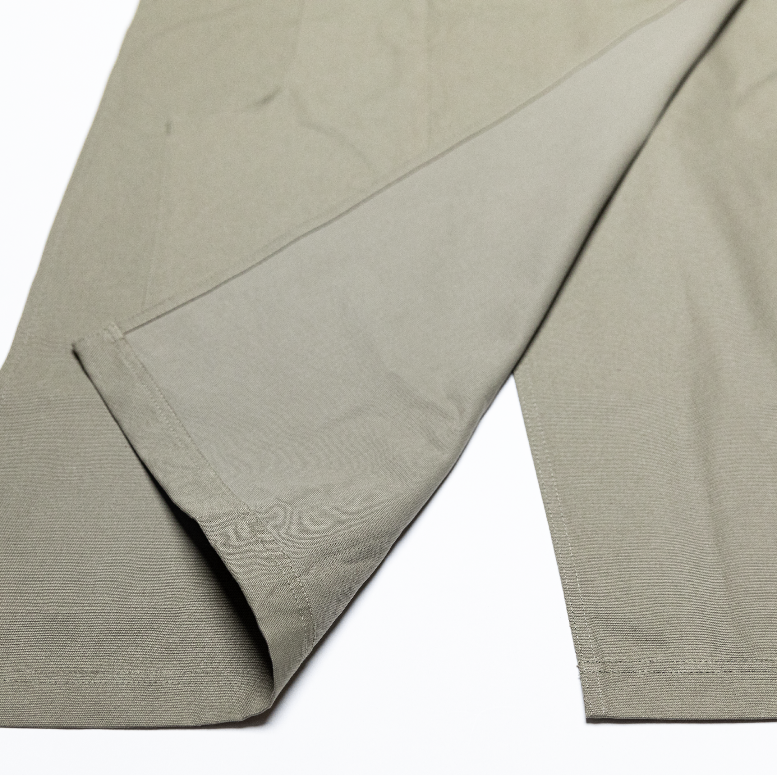 Close-up of the apron's split-front design that keeps fabric away from the pottery wheel during throwing
