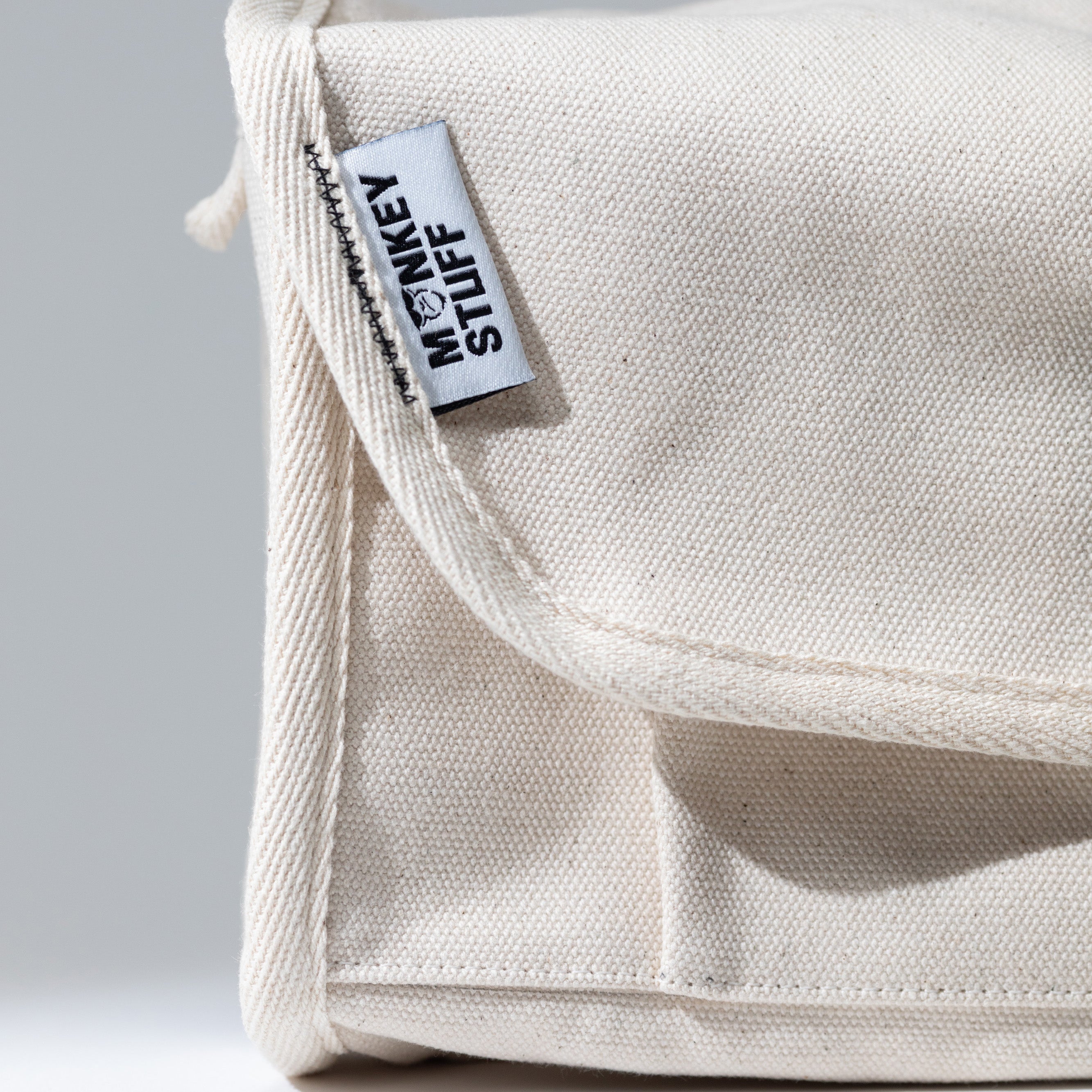 Close-up of the tech pouch's recycled canvas exterior buckle — durable everyday carry