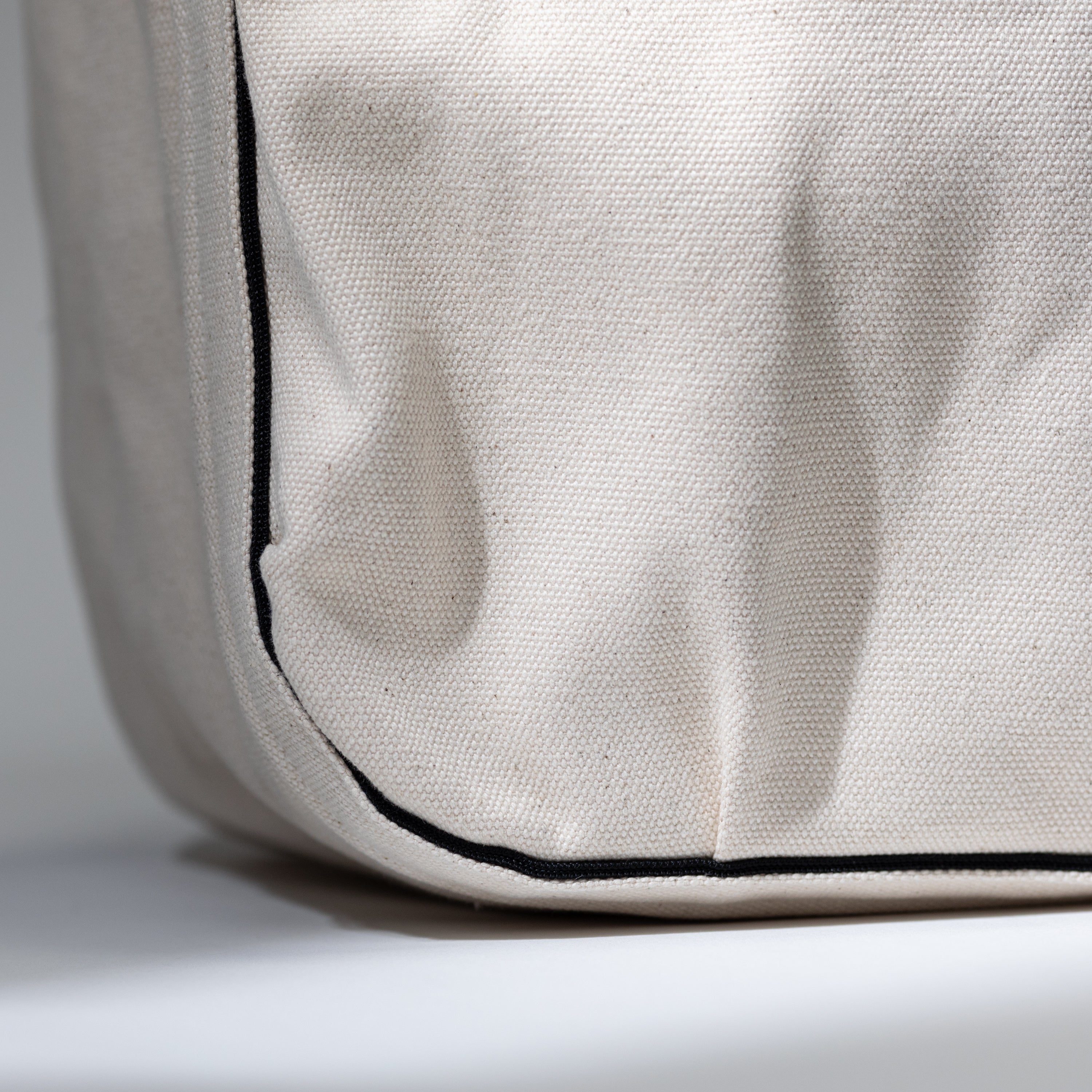 Close-up of the medium tool bag's recycled cotton canvas exterior and accents — durable studio-grade materials