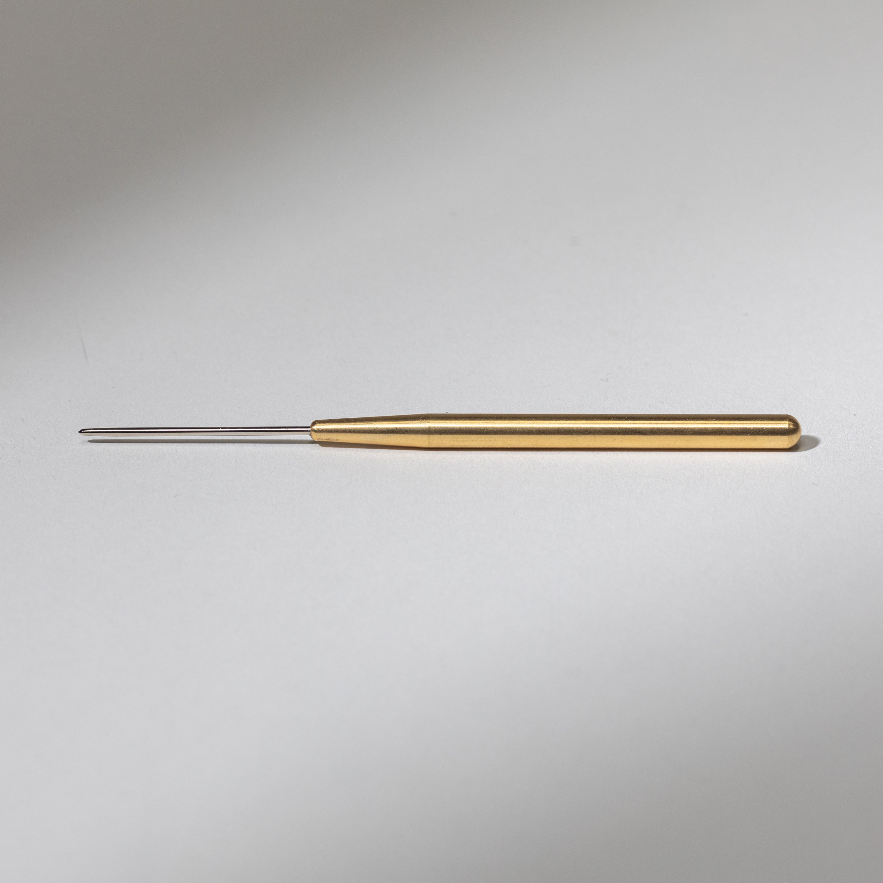 Monkey Stuff brass needle tool — solid machined brass body with fine steel scoring tip